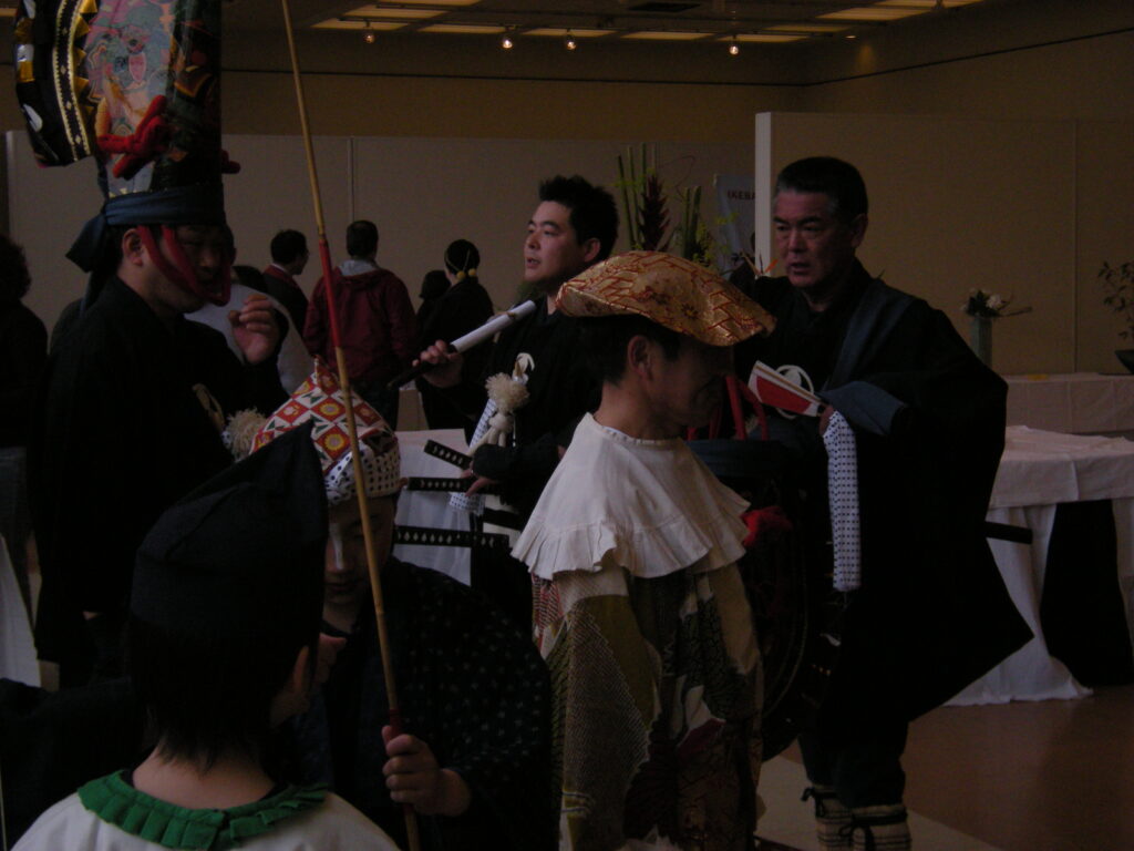 Dancers performing the Hachinohe Enburi with tall lacquered hats