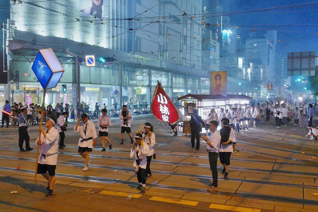 Spirit boat procession on the streets of Nagasaki during Shoro Nagashi
