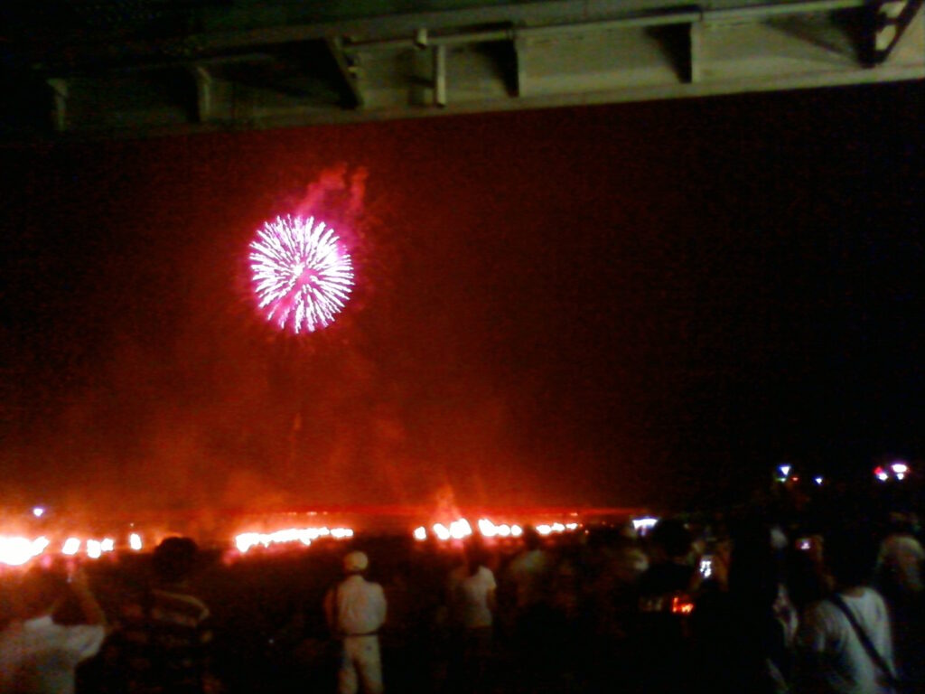 Bonfires burning along the Fuji River at the Nanbu Fire Festival, Yamanashi