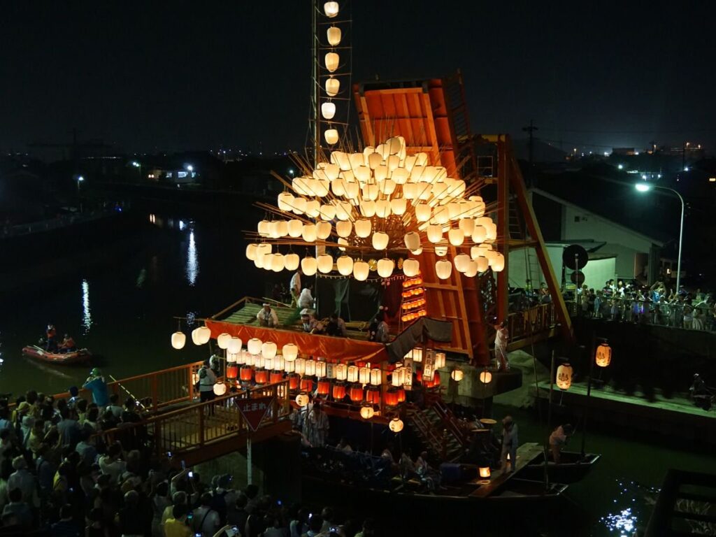 Lantern-covered makiwara boat on the Kanie River at the Sunari Matsuri evening festival