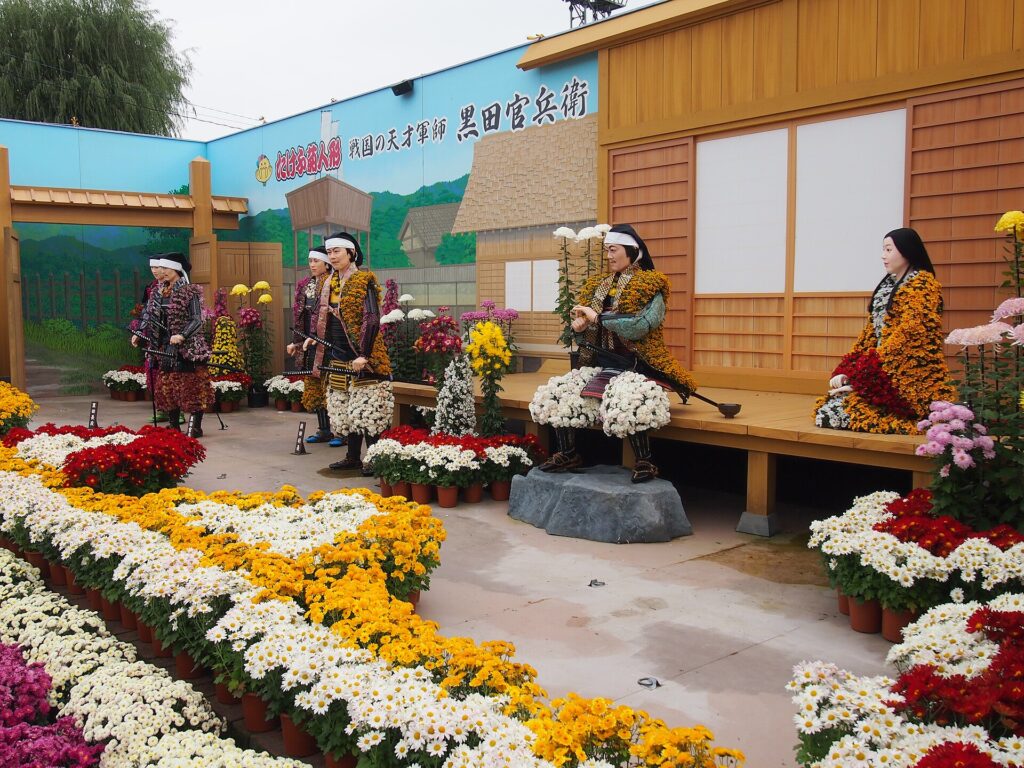 Life-size dolls covered in chrysanthemum blooms at the Takefu Kikuningyo exhibition