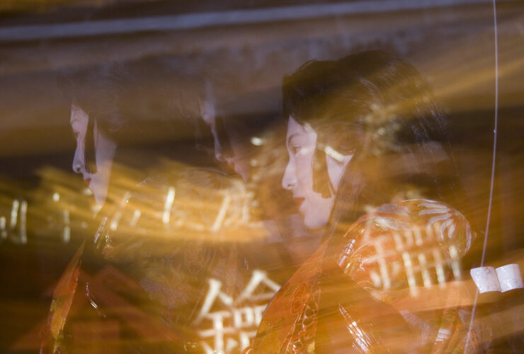 Woman in kimono amid bamboo lantern light at Usuki Takeyoi festival