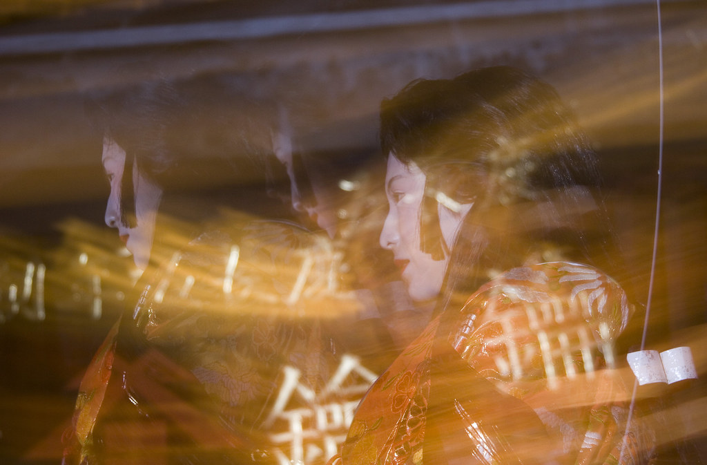 Woman in kimono amid bamboo lantern light at Usuki Takeyoi festival