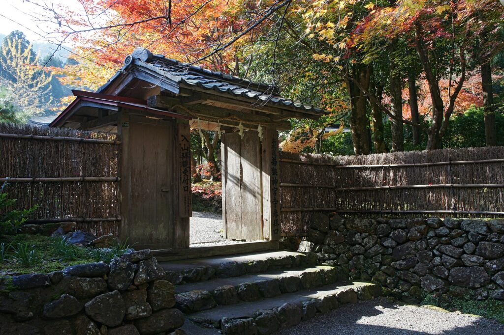 The gate of Wakasa Jinguji temple in Obama, Fukui, framed by autumn maples