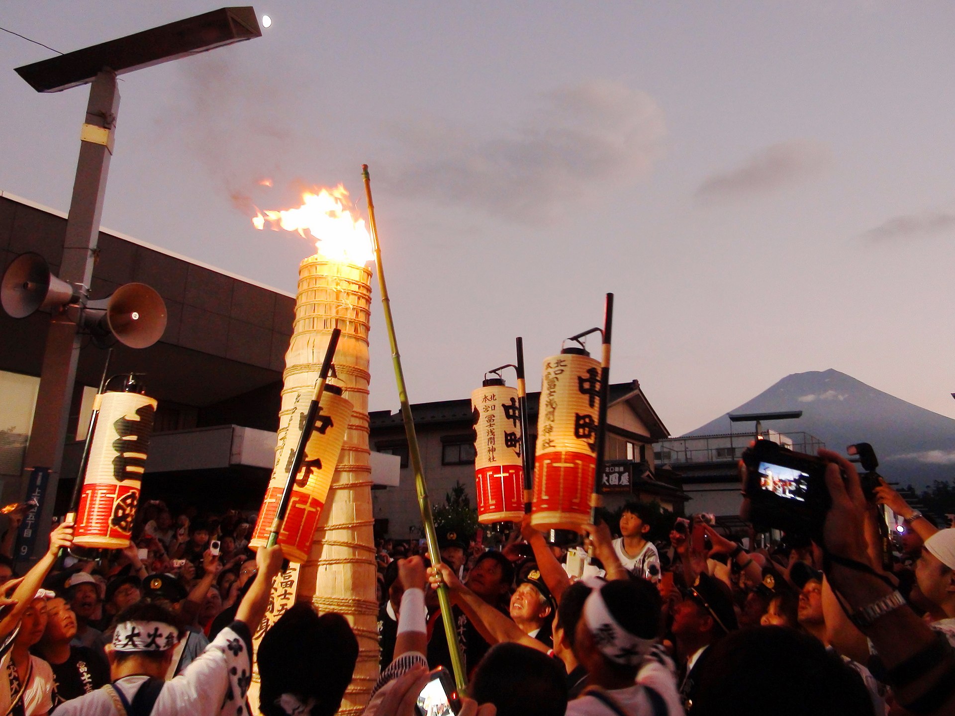 Giant torches burning along the street at the Yoshida Fire Festival