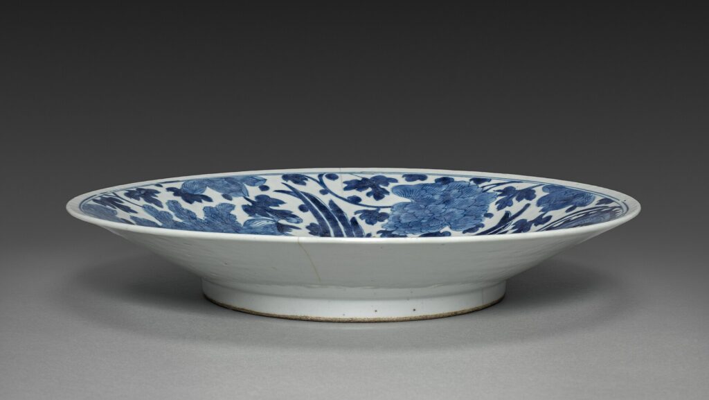 An antique Arita ware porcelain plate with blue and coloured decoration