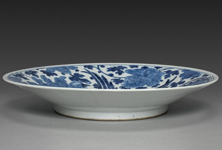 An antique Arita ware porcelain plate with blue and coloured decoration