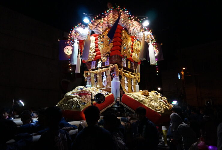 An illuminated chosa drum float carried through the streets at night in Kagawa